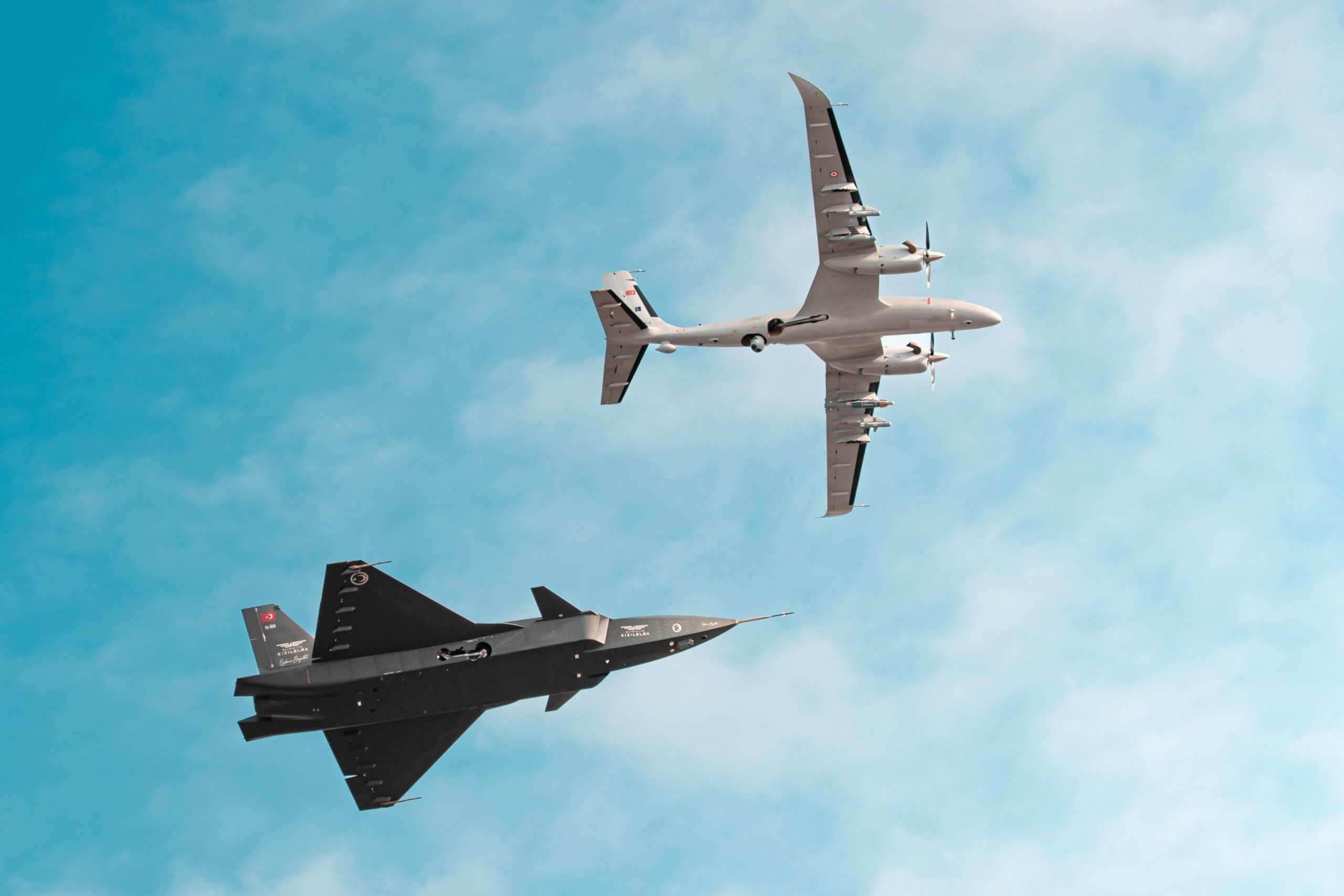 A dynamic view of two fighter jets performing an aerobatic maneuver in a clear blue sky.
